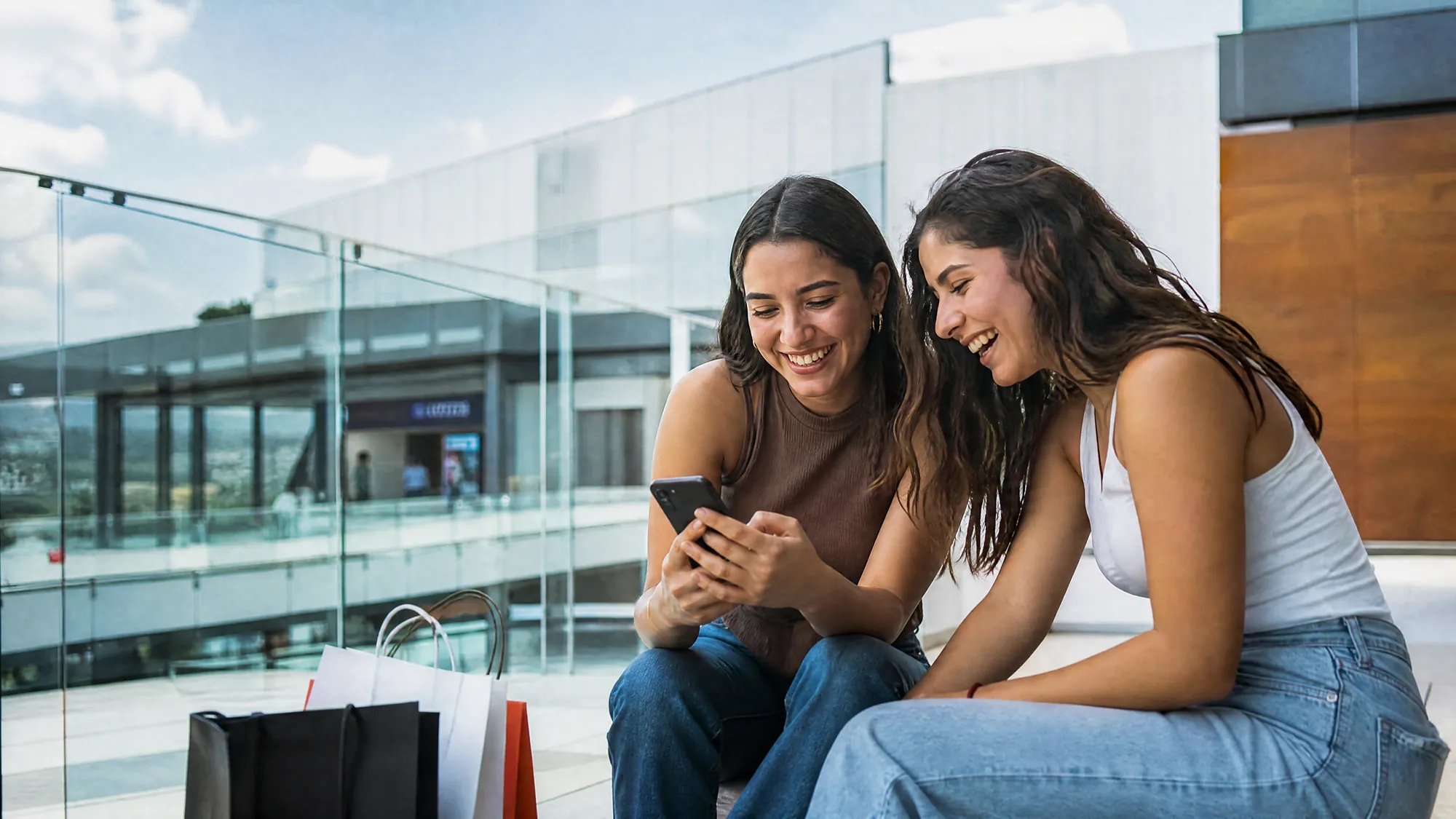 Two friends checking a purchase on a phone