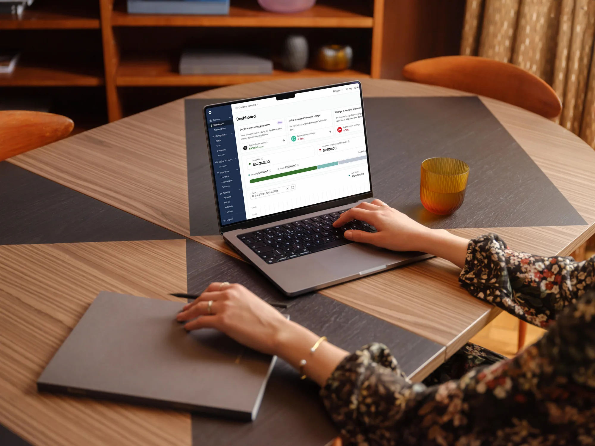 Someone working in the Clara dashboard at a café table